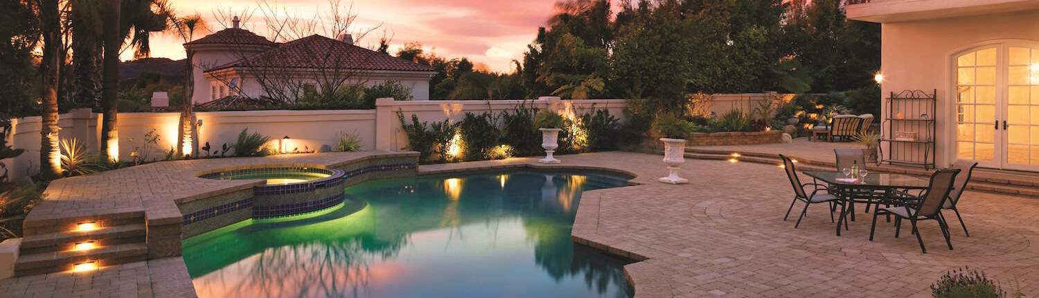 Lit Pool next to Paving Stone Floor