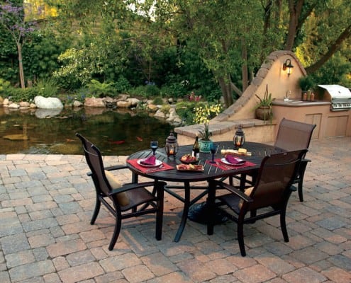 Formal patio dining next to koi pond