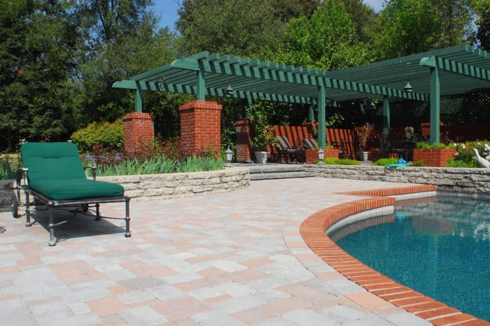Pergola next to Paving Stone and Pool