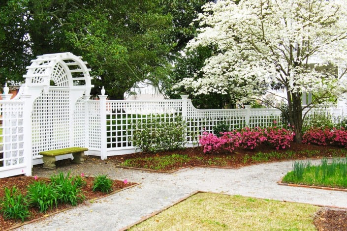 Fence Carpentry next to Walkway and Garden