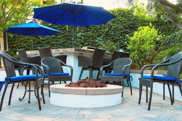 Fire Pit with in the Center of Outdoor Chairs with Blue Cushions