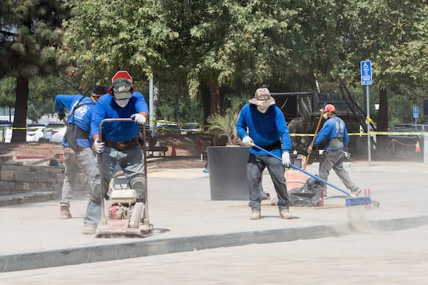 men cleaning pavement