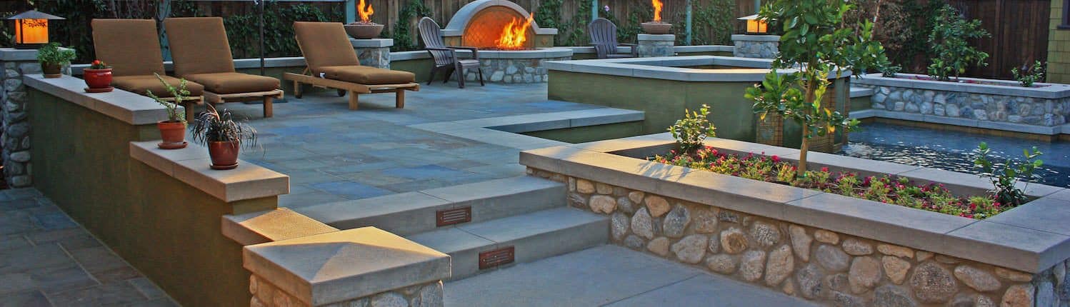 Minimalist landscaping using hardscapes, walls, water, and fire features