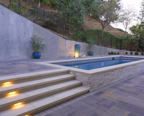 Modern pool with paving stone pool deck