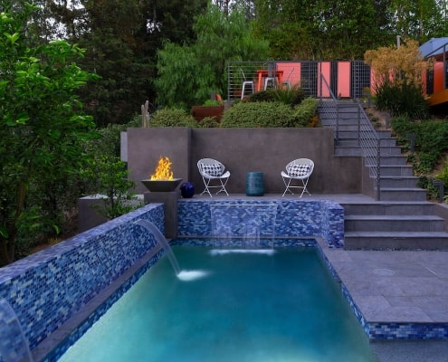 Modern pool with fire feature and waterfall