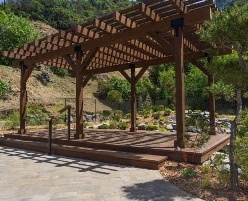 Free standing pergola with paving stone walkway