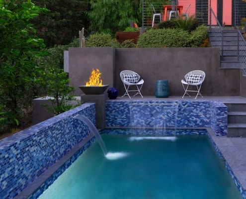 Fire bowl on the side of the pool outdoor design