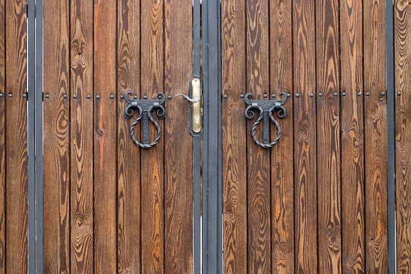 wooden gate with wrought iron elements close up